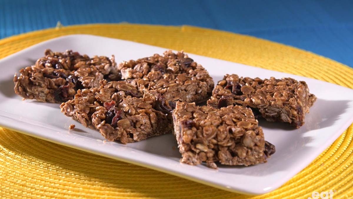 No-Bake Chocolate Cherry Oat Bars A rectangular white plate of four chocolate cherry oat bars.